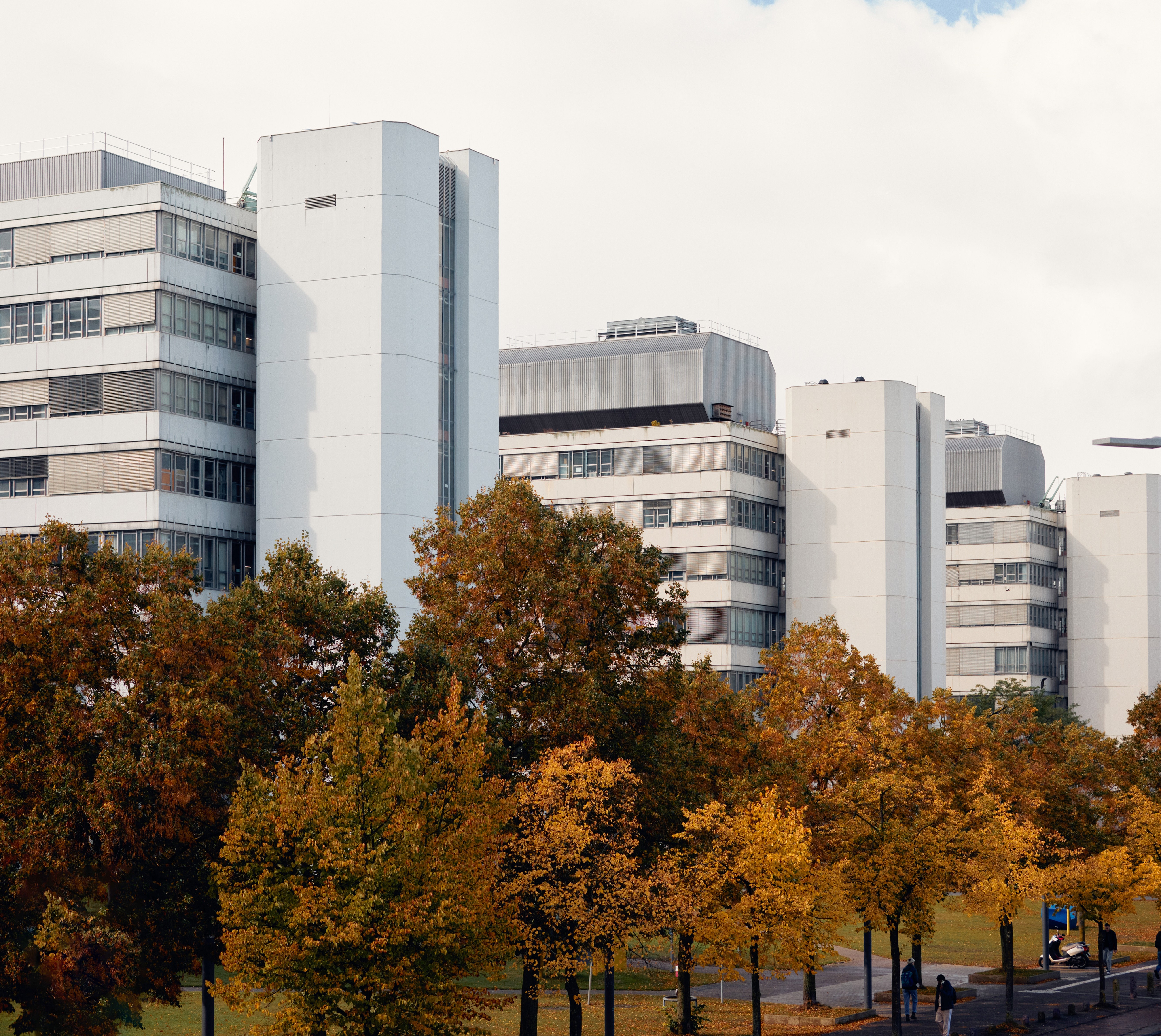 Bielefeld University building with autumn colored trees in foreground
